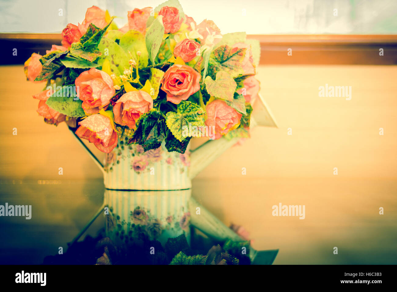 Beautiful flowers in vase on blue background.Vintage style Stock Photo