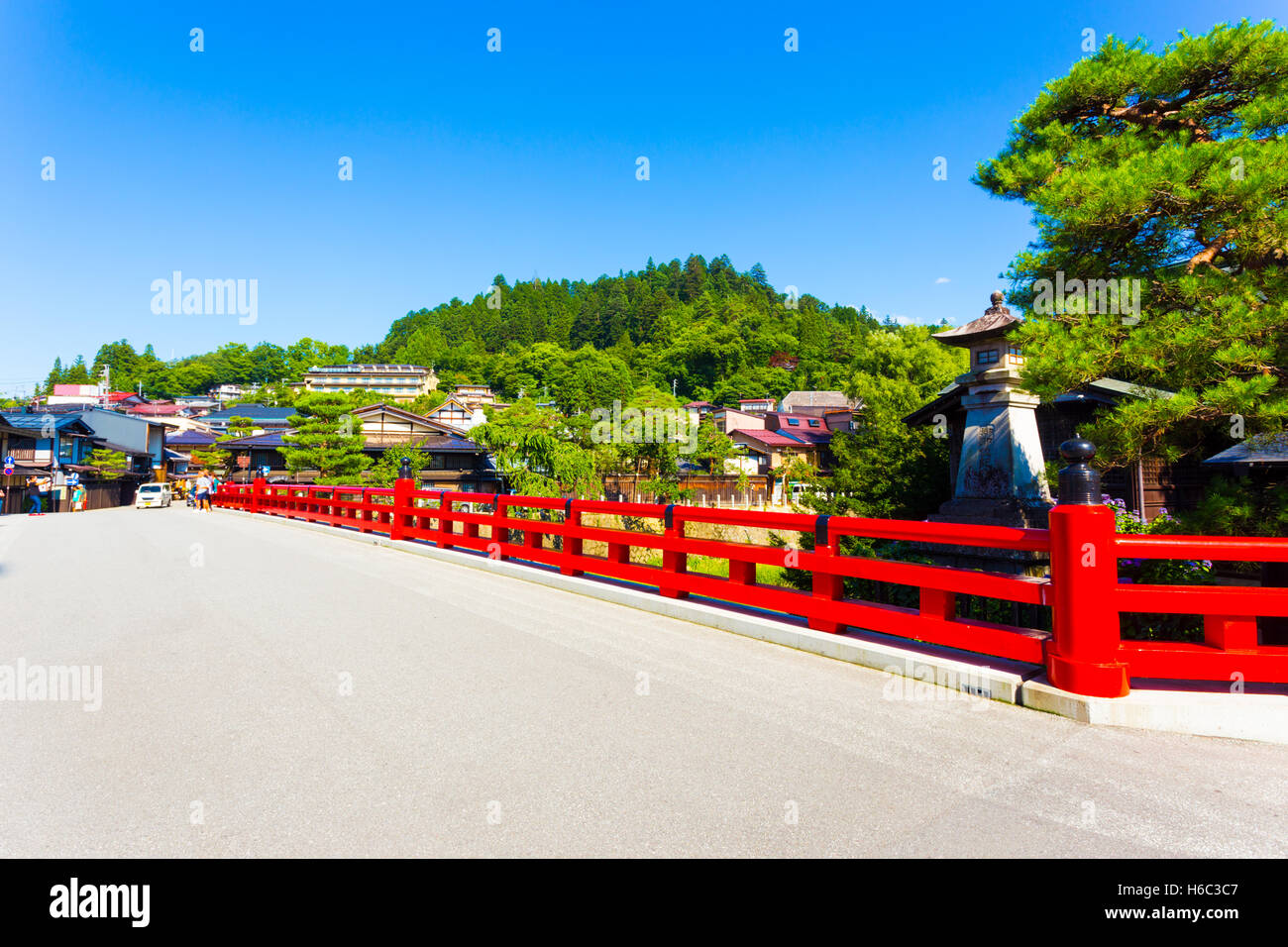 Bright red Naka-Bashi bridge marks the entrance to historic old town, a tourist destination in the mountains of Hida-Takakayama Stock Photo