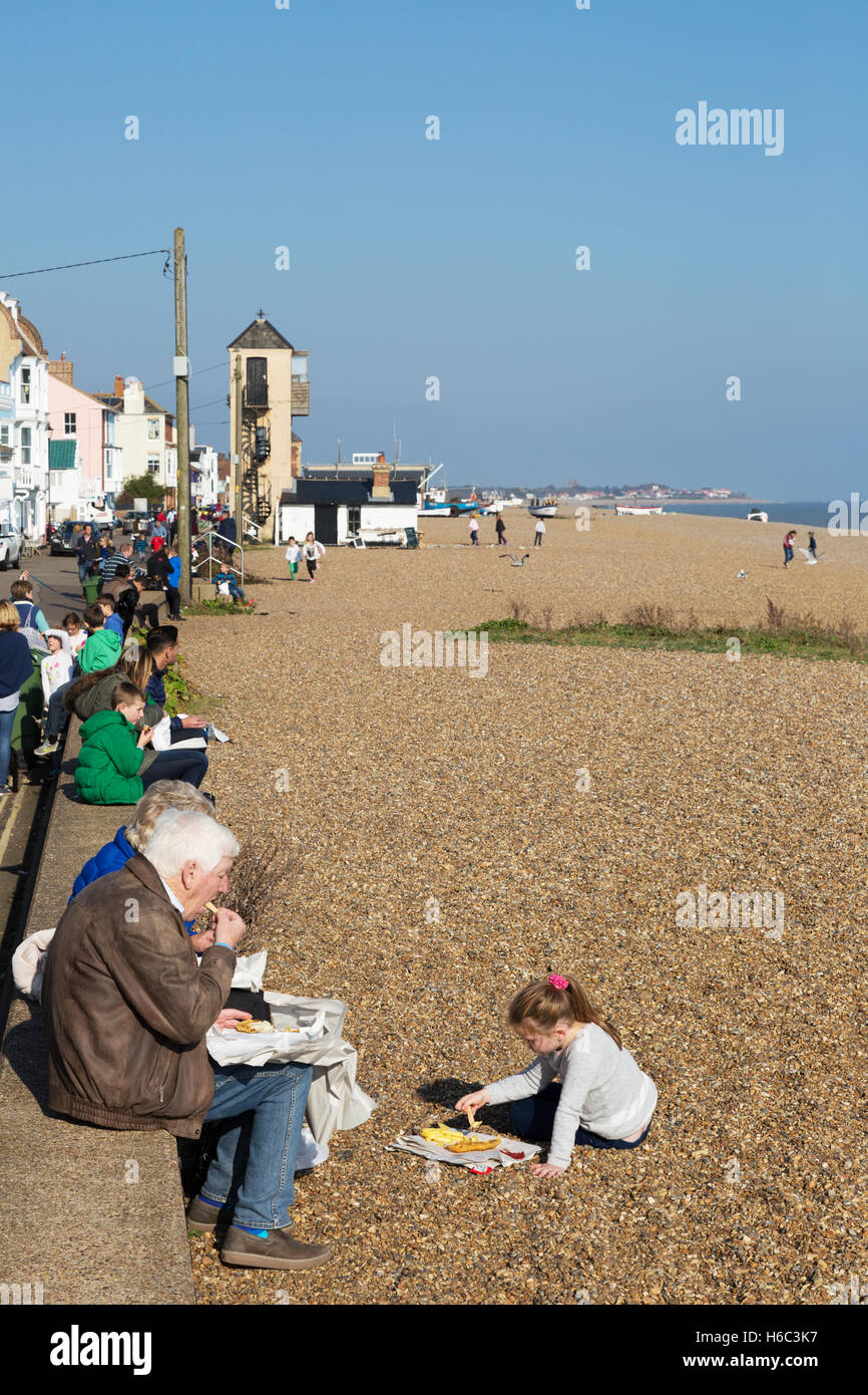 A family eating fish and chips on Aldeburgh beach, Aldeburgh, Suffolk England UK Stock Photo