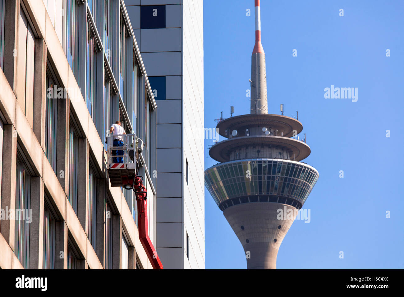 Germany, Duesseldorf, the television tower,  window cleaners at an office building at the Medienhafen (Media harbour). Stock Photo