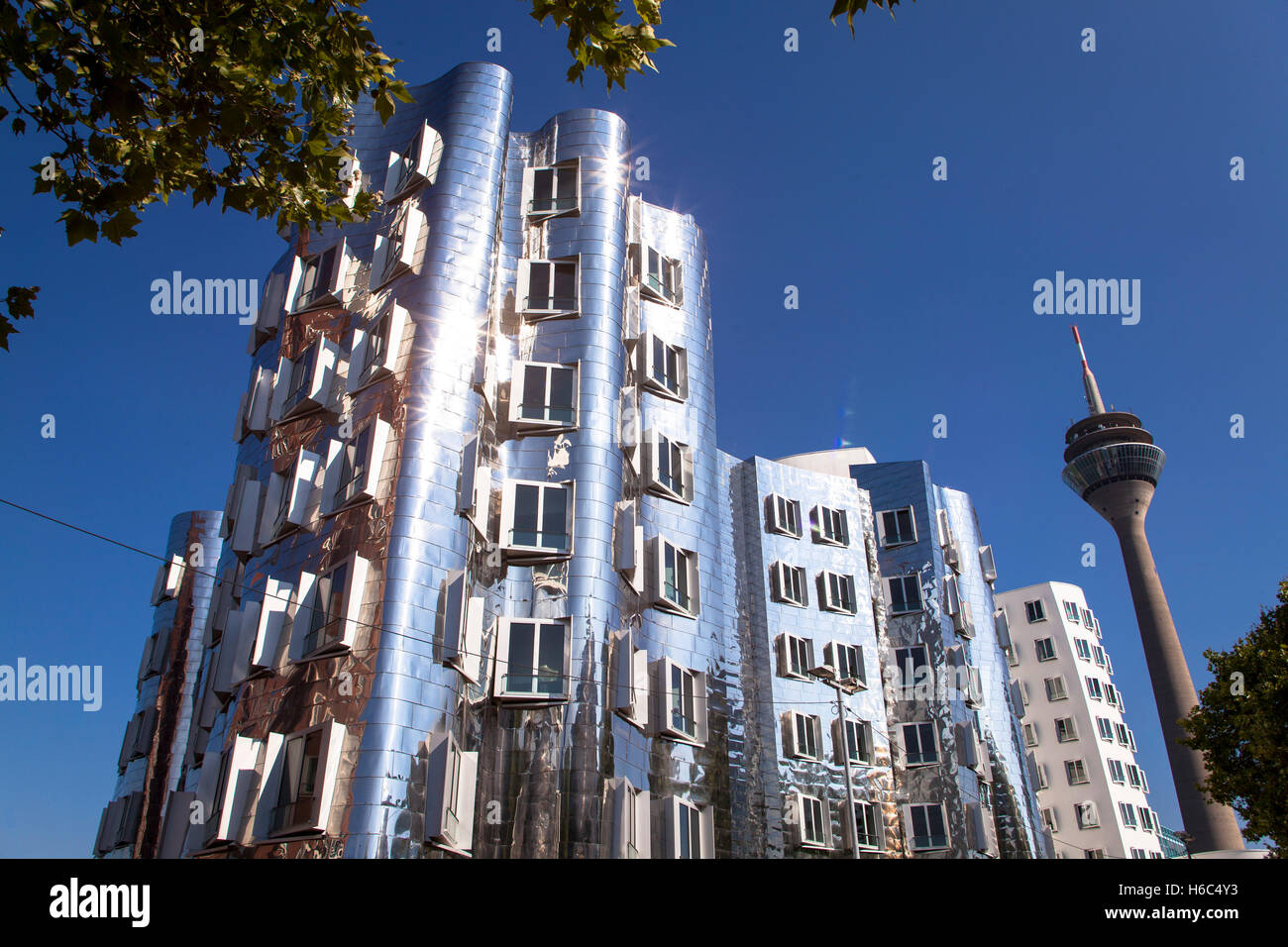 Germany, Duesseldorf, the buildings Neuer Zollhof by Frank O. Gehry at the harbor Medienhafen, television tower. Stock Photo