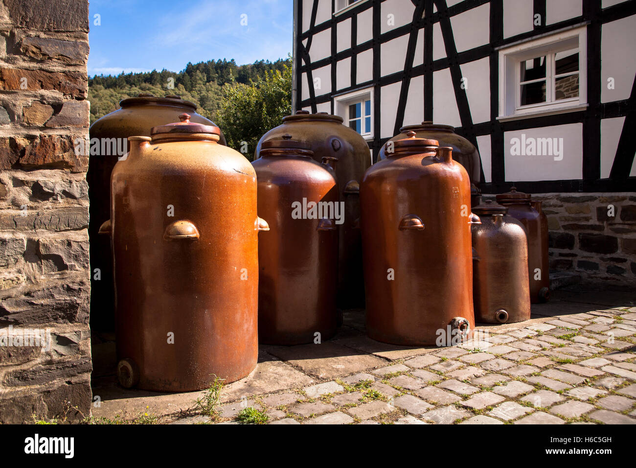 Germany, Hagen, Hagen Open-air Museum, large clay jugs in front of the old vinegar brewery and the mustard mill. Stock Photo