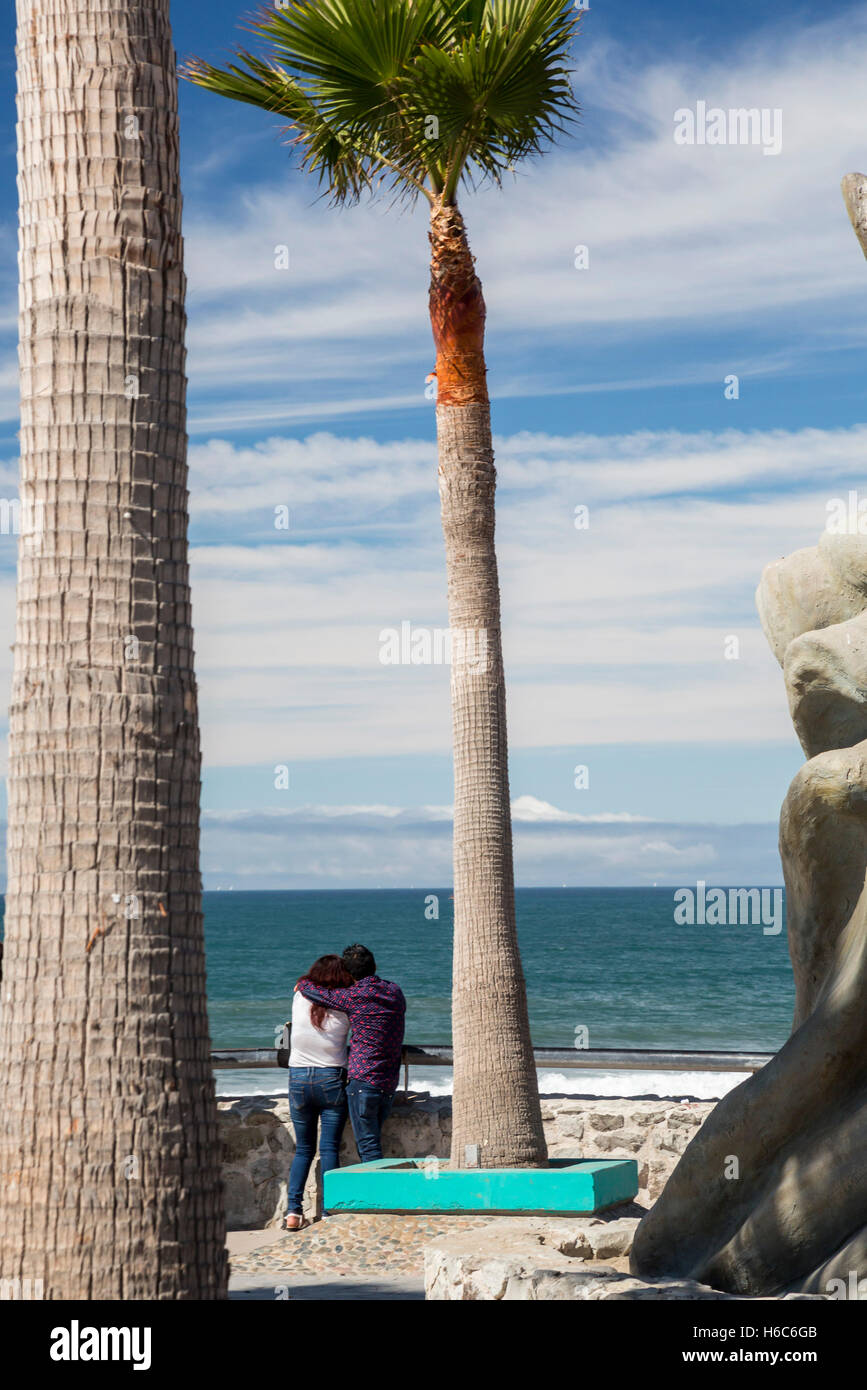 Tijuana, Mexico - A couple at the Pacific Ocean, just south of the U.S. border. Stock Photo