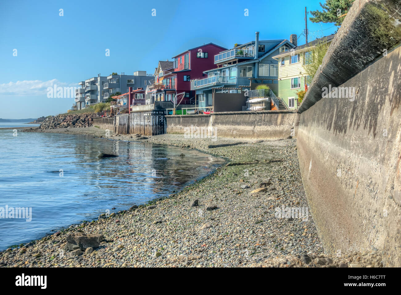 Residences sit above a seawall in West Seattle, Washington. HDR image. Stock Photo