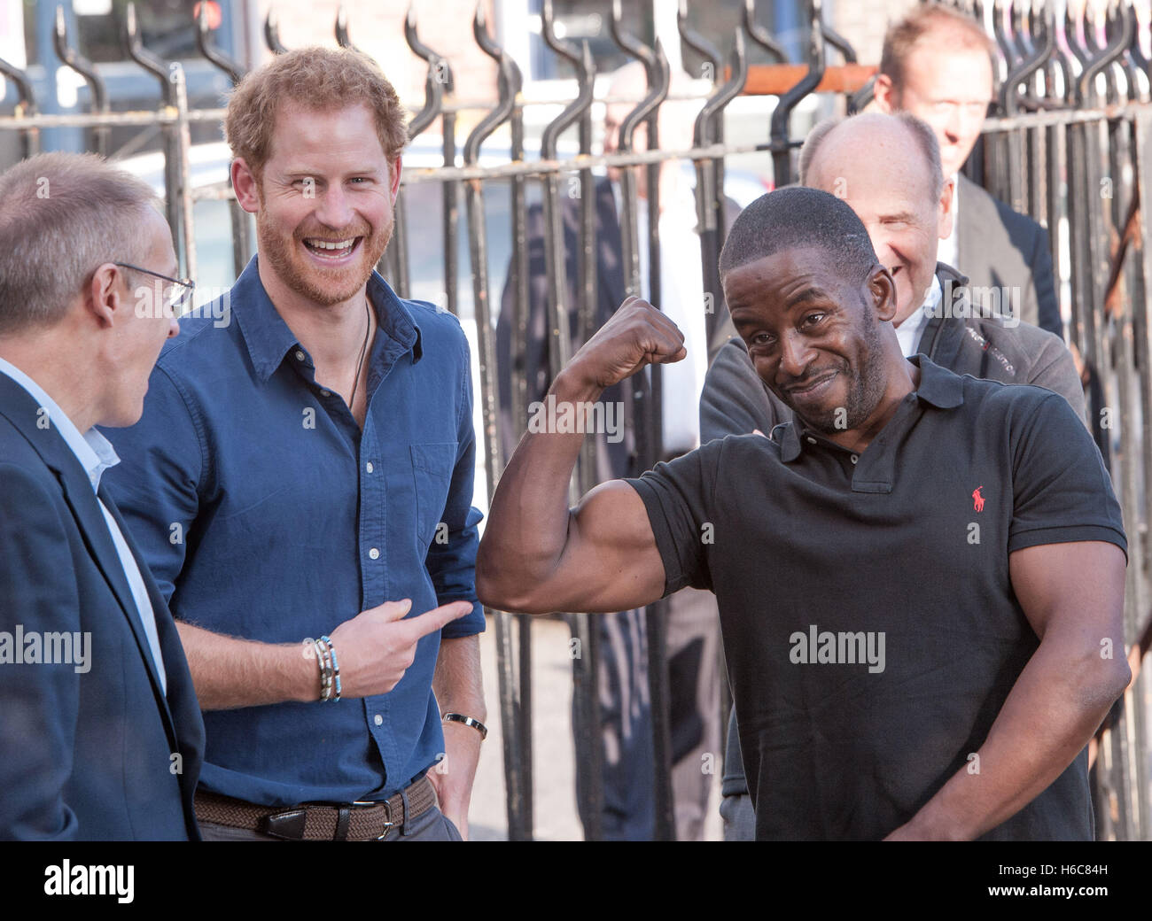 Prince Harry laughs with Centre Manager Trevor Rose (right) as he arrives to visit a recording studio at the Russell Youth Club in the St Ann's area of Nottingham during a day of visits to the city focused on young people and communities. Stock Photo