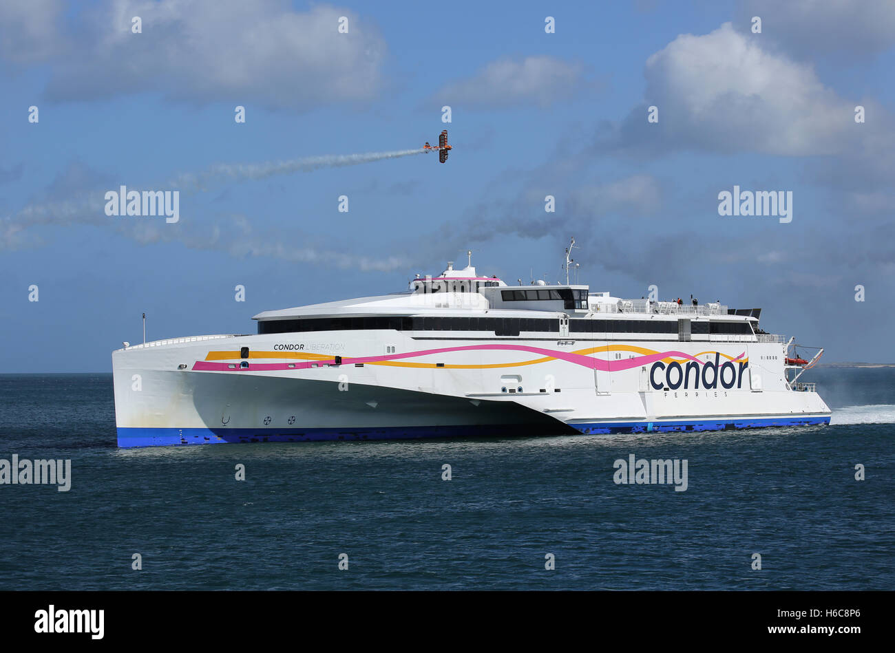 The Condor Liberation high speed car ferry slowing down as it enters St. Peter Port in Guernsey from Poole in Dorset. Stock Photo