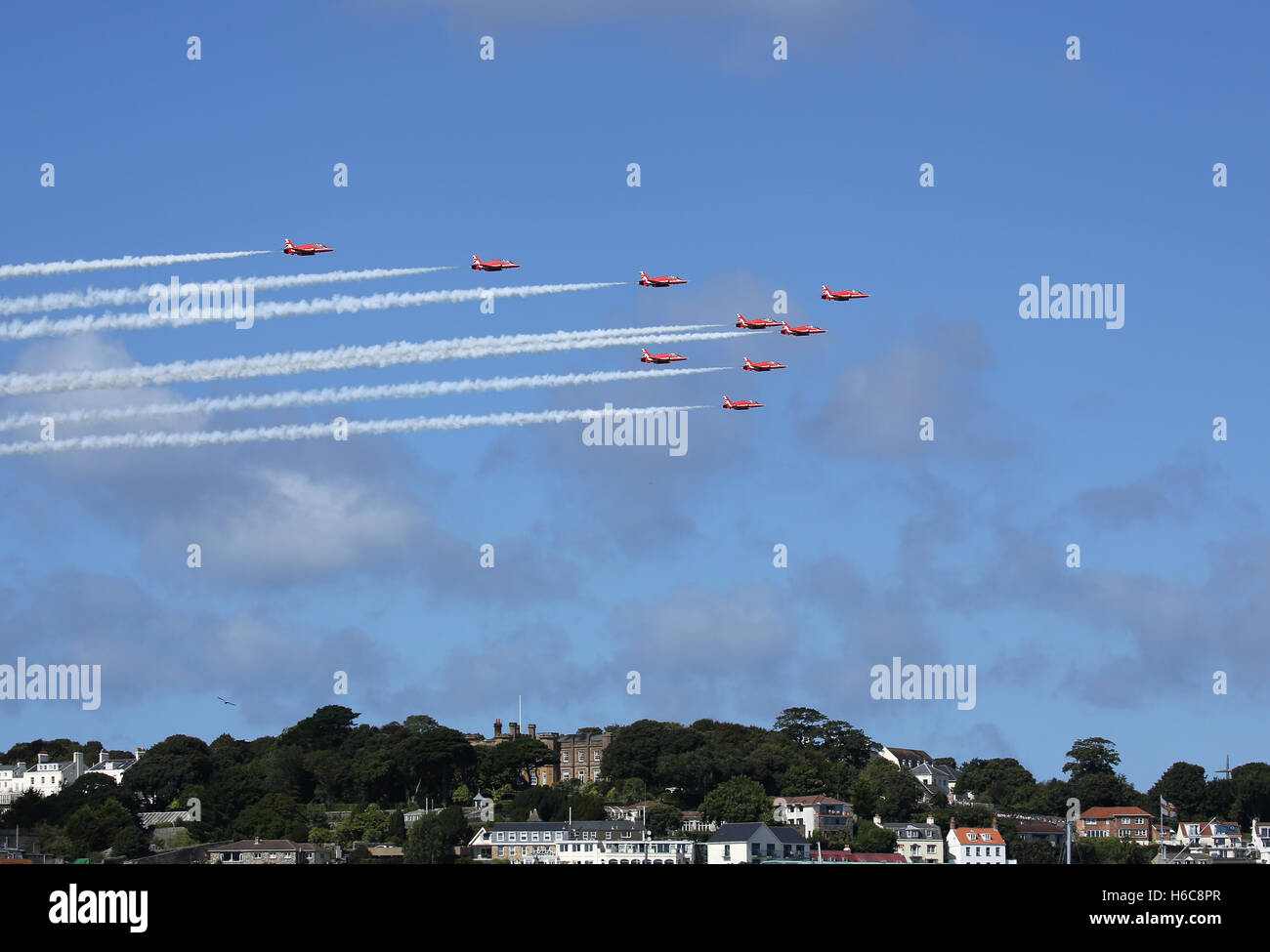 The Royal Air Force Red Arrows displaying at the Guernsey Airshow over St.Peter Port Stock Photo