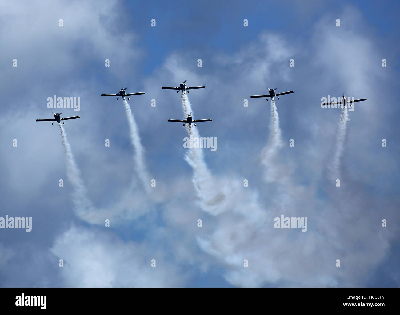 All six Vans aircraft of Team Raven displaying over St. Peter Port, Guernsey. Stock Photo