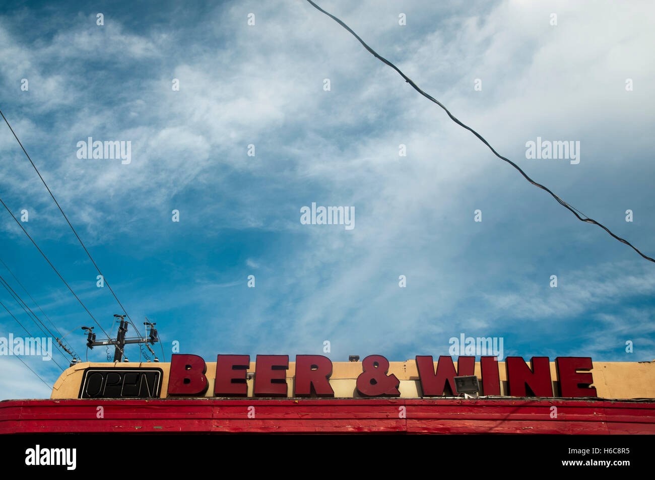 Beer & wine sign above a gas station/convenience store forecourt Stock