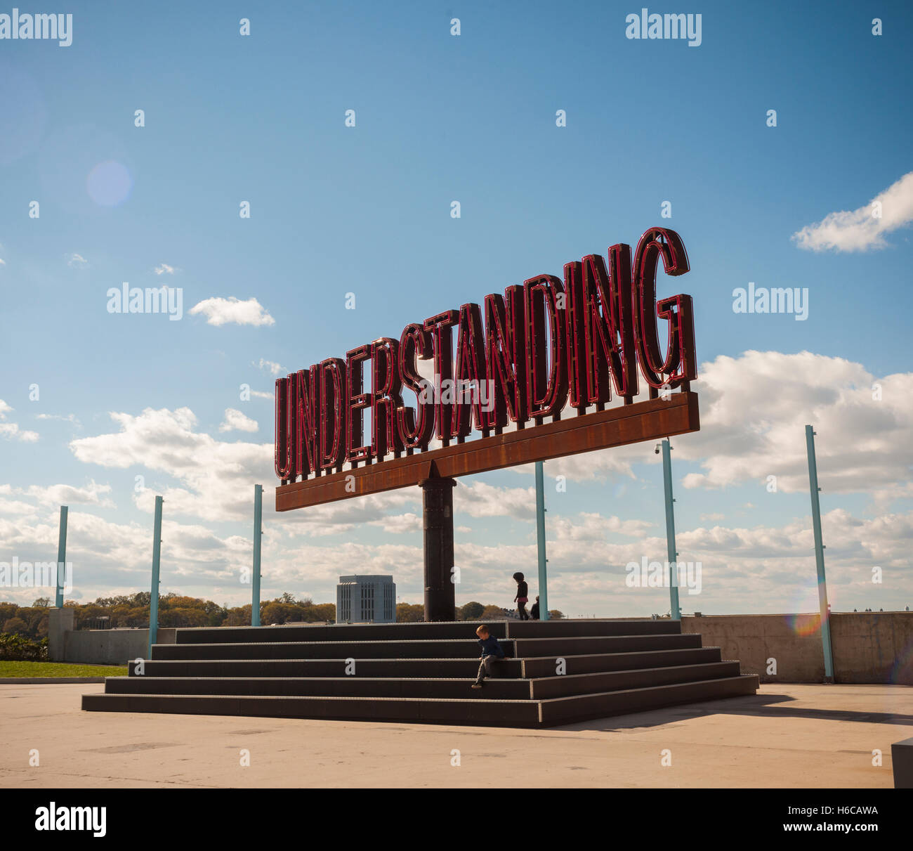 The rotating 'Understanding' public art sculpture in Brooklyn Bridge Park in New York on Sunday, October 23, 2016. 'Understanding' by the artist Martin Creed features a 25 foot tall rotating red sculpture spelling out the word understanding reminiscent of a billboard on the side of a highway.  (© Richard B. Levine) Stock Photo