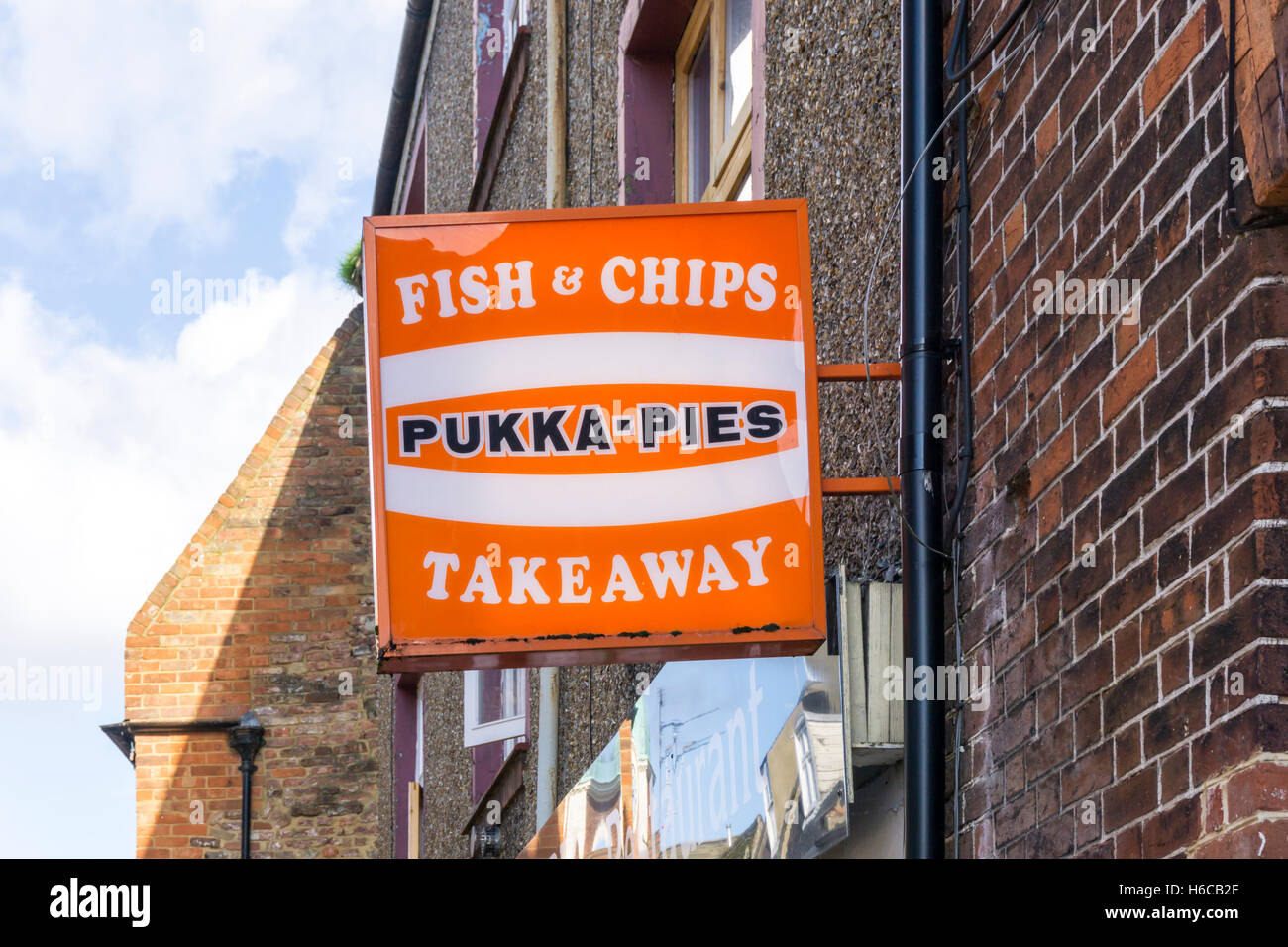 A Pukka-Pies sign outside a fish & chips shop. Stock Photo