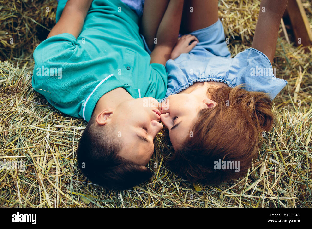 man and woman lie on hay Stock Photo Alamy