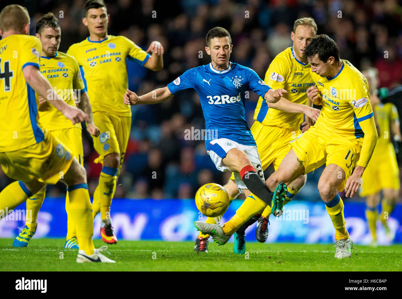 Rangers' Jason Holt (centre) and St Johnstone's Joseph Shaughnessy compete for the ball during the Ladbrokes Scottish Premiership match at the Ibrox Stadium, Glasgow. Stock Photo