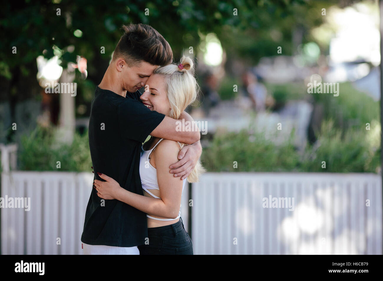 Happy young couple at a park Stock Photo - Alamy