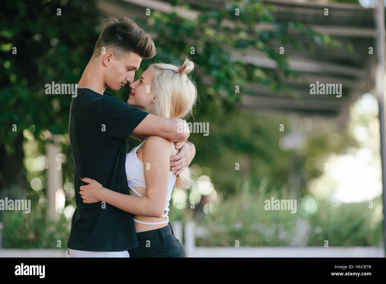 Happy young couple at a park Stock Photo - Alamy