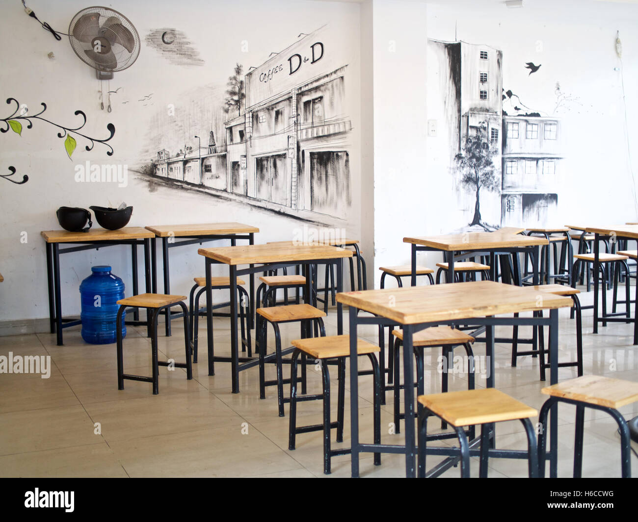 Cafe wall art timbre wooden tables chairs stools Stock Photo