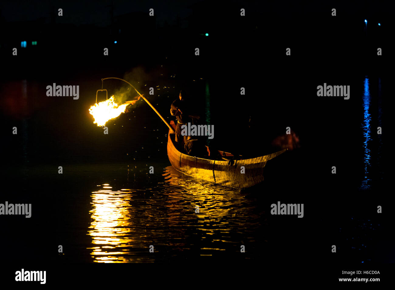 Night fire is used to help cormorant bird catch fish in a traditional form of Japanese fishing, ukai by firelight on Kiso River Stock Photo