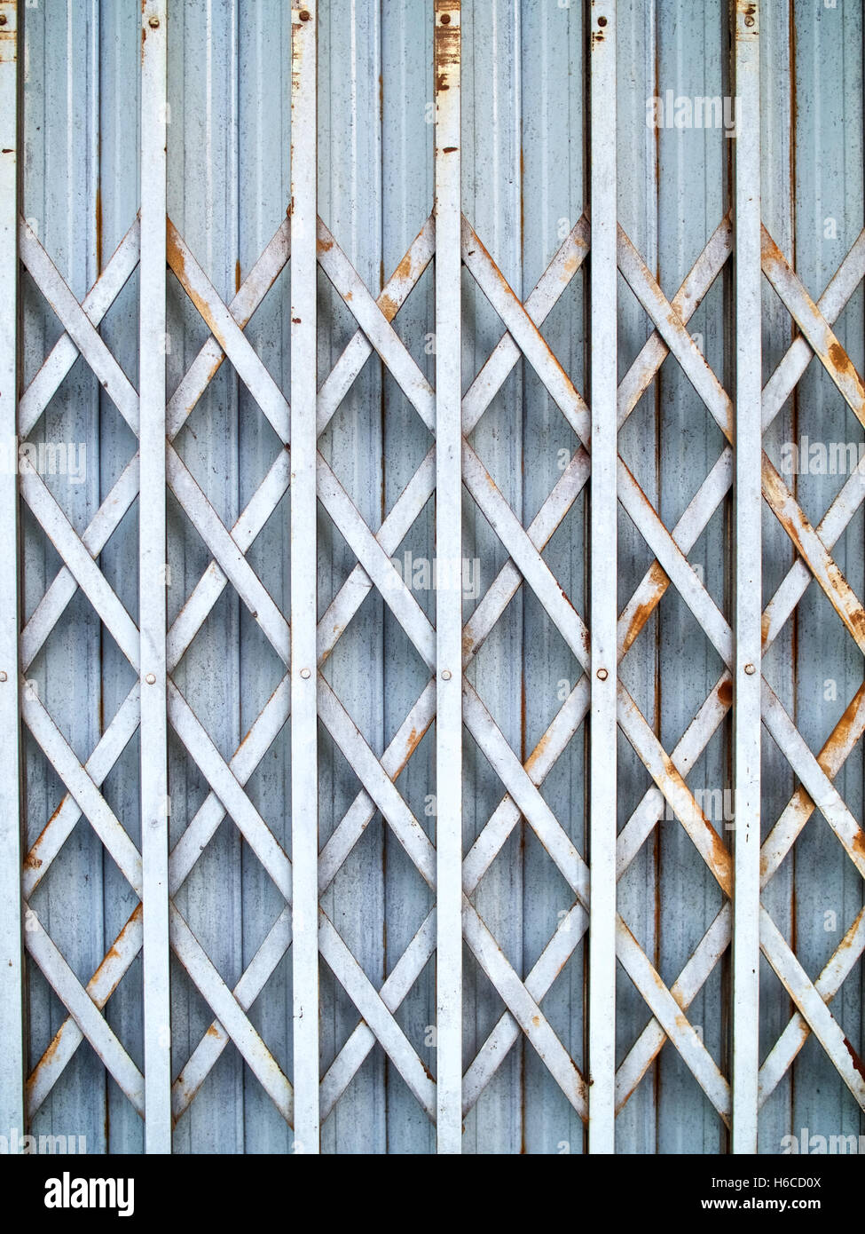 Metal gate folding rust blue light Stock Photo