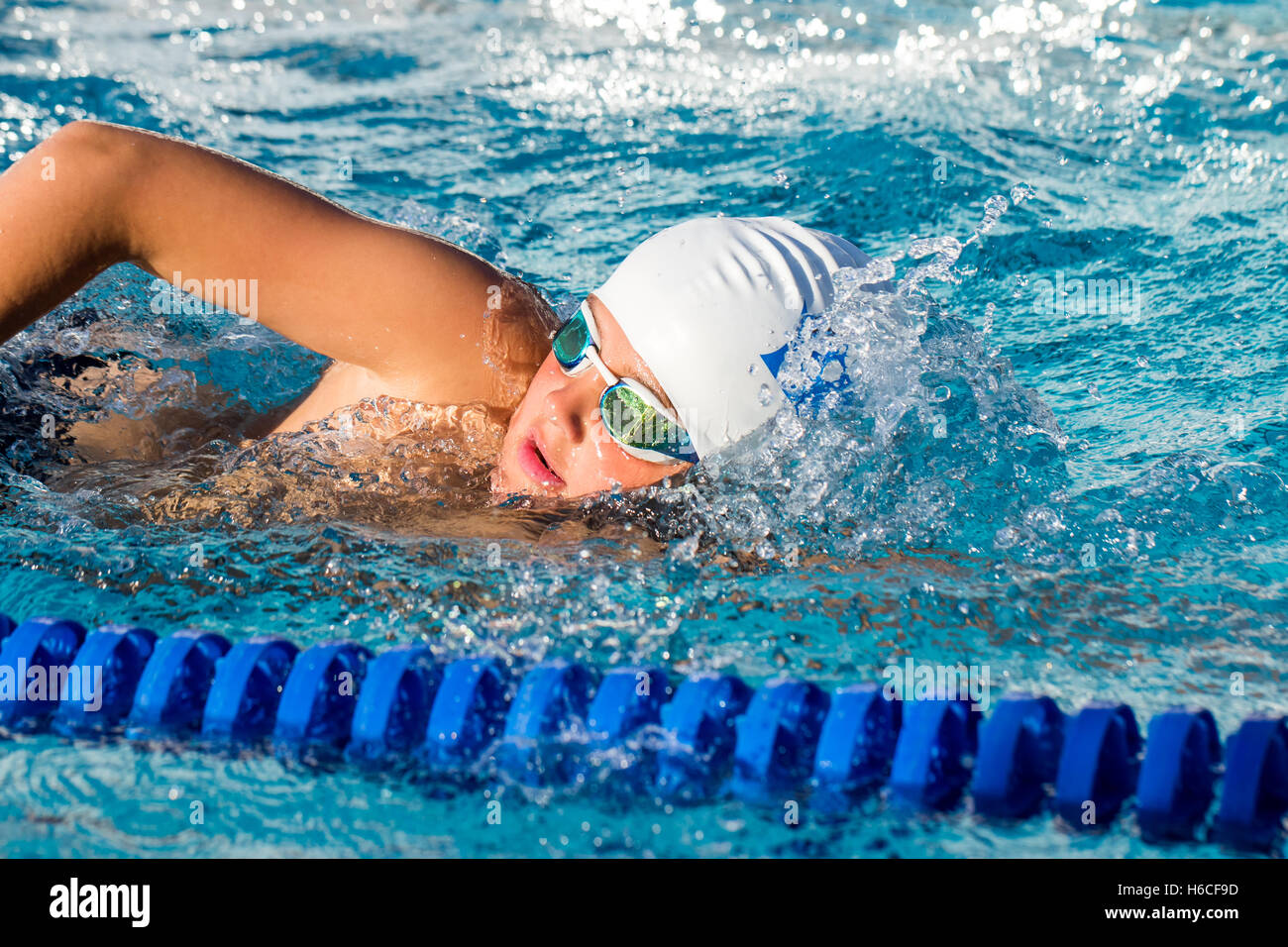 Close up action shot of young swim student at swimming practice. Stock Photo