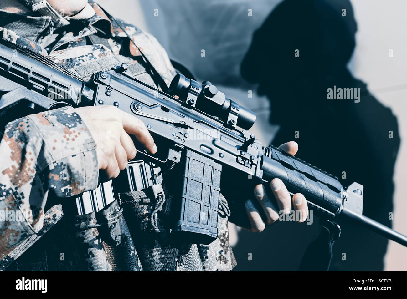 Soldier with assault rifle, officer give orders Stock Photo