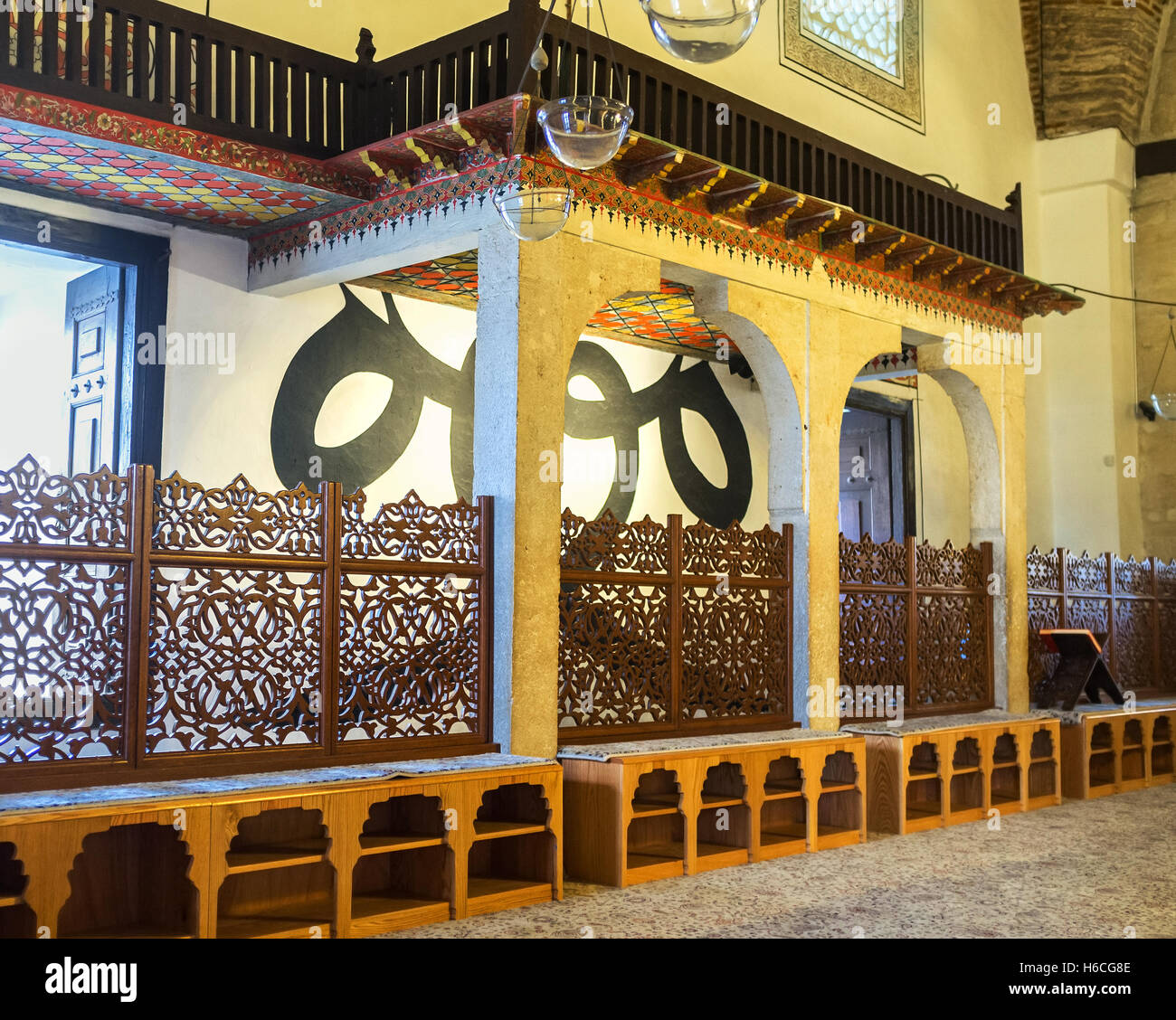The prayer hall of the mosque in Mevlana Museum is separated with the beautiful carved wooden grilles Stock Photo