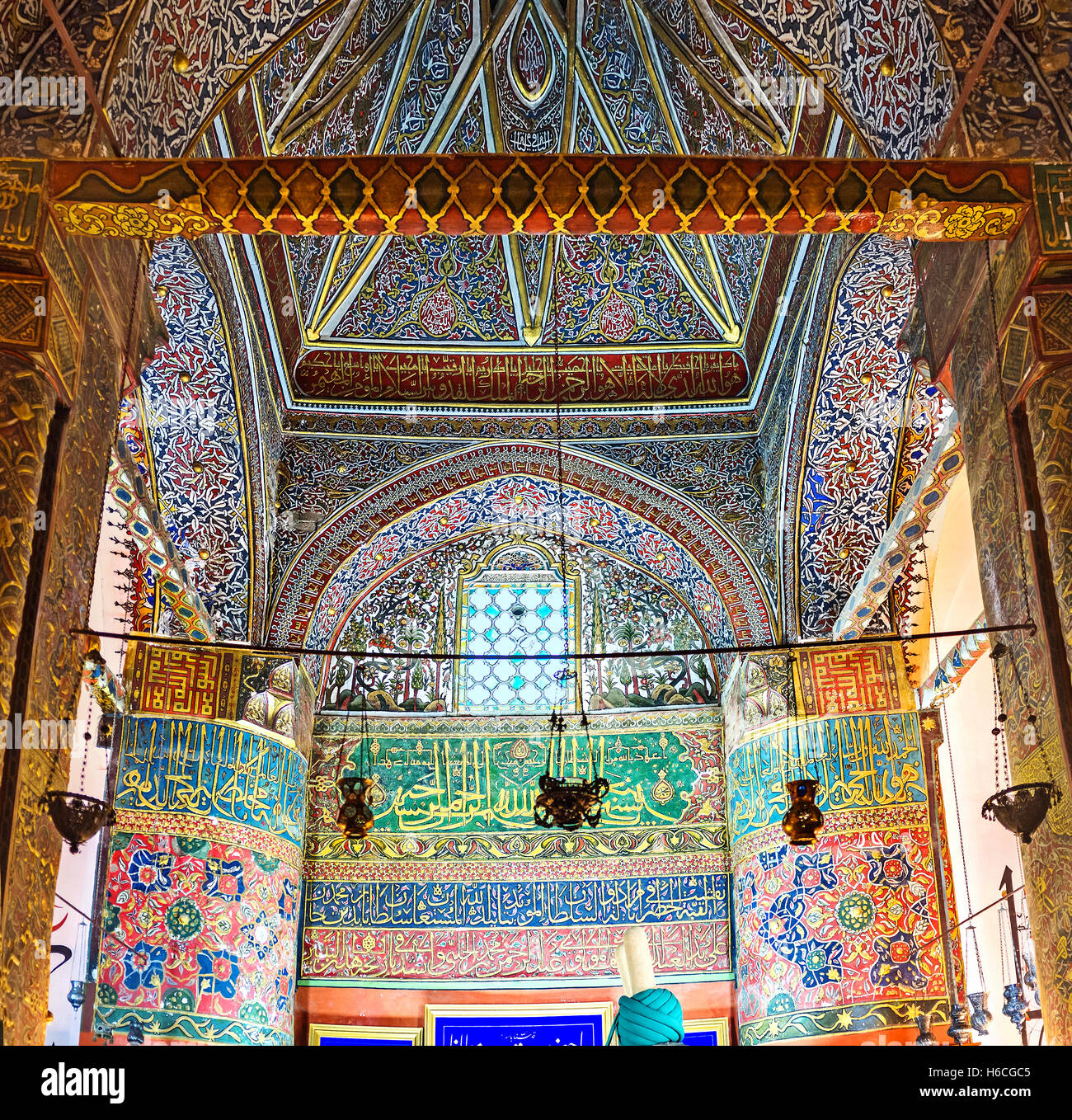 The interior of the burial chamber in Mevlana Mausoleum, that boasts colorful islamic ornamentations with old arabic calligraphy Stock Photo