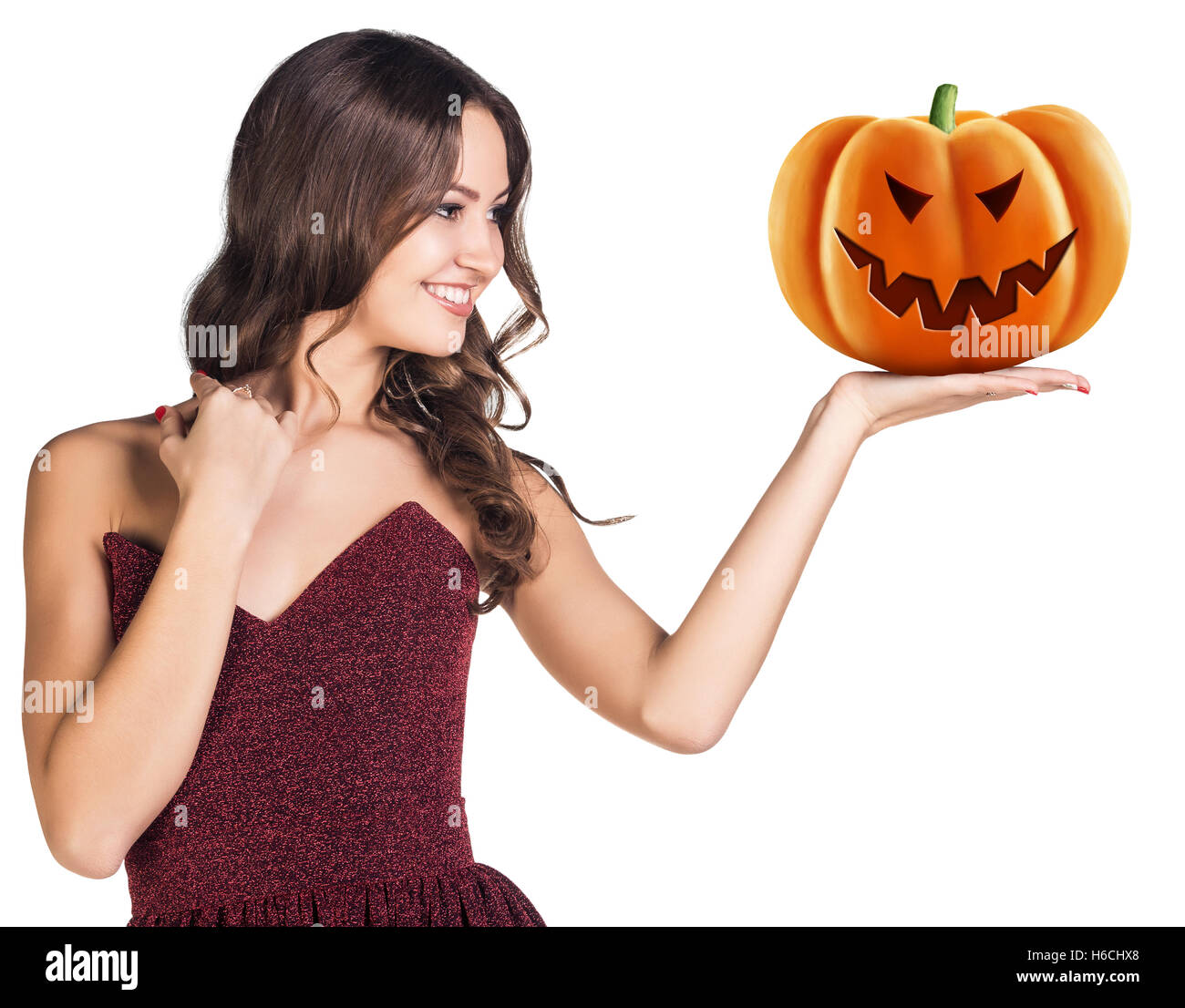Young woman holding carved pumpkin. Stock Photo