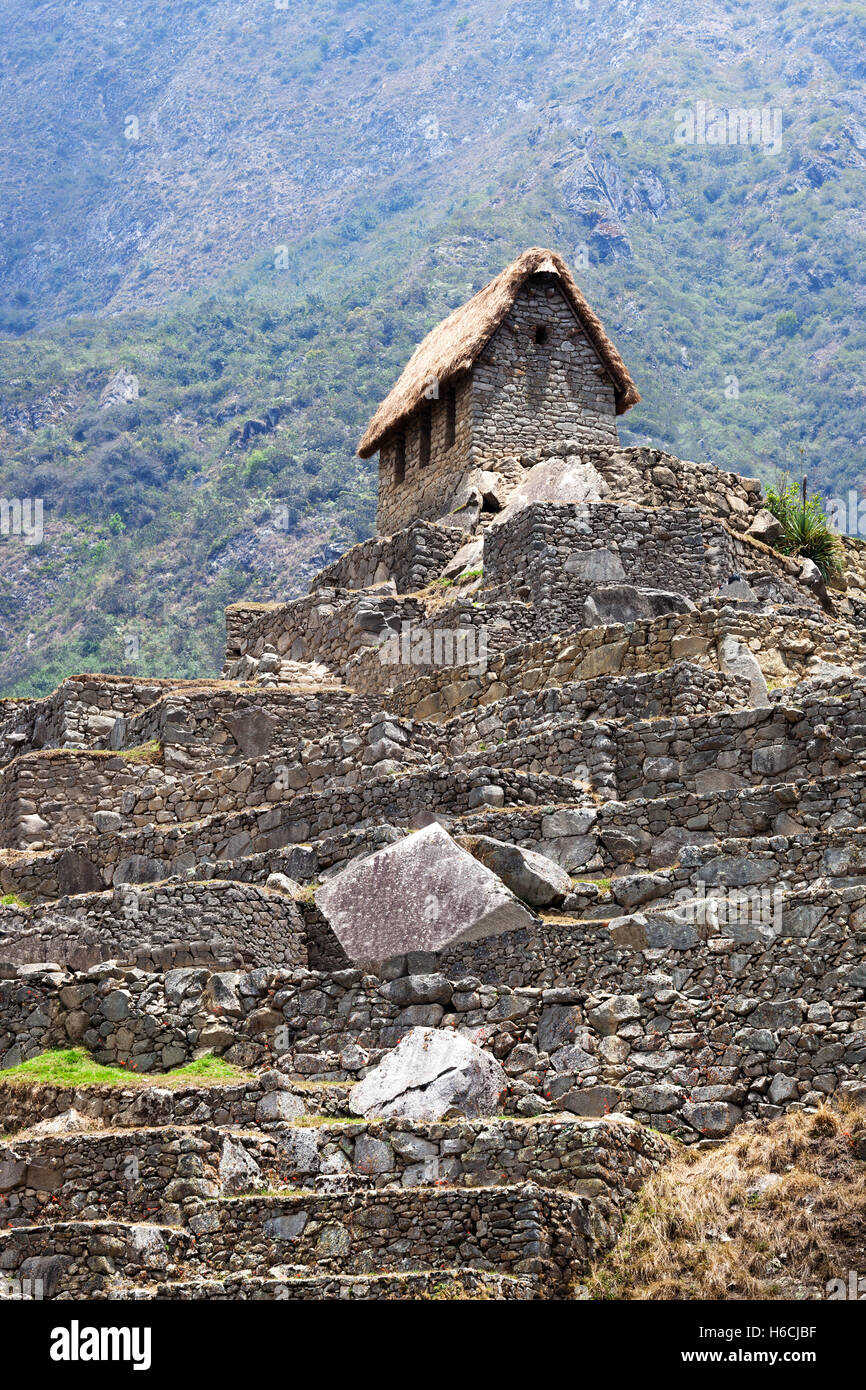 old house in Machu Picchu mountains in the background Stock Photo - Alamy