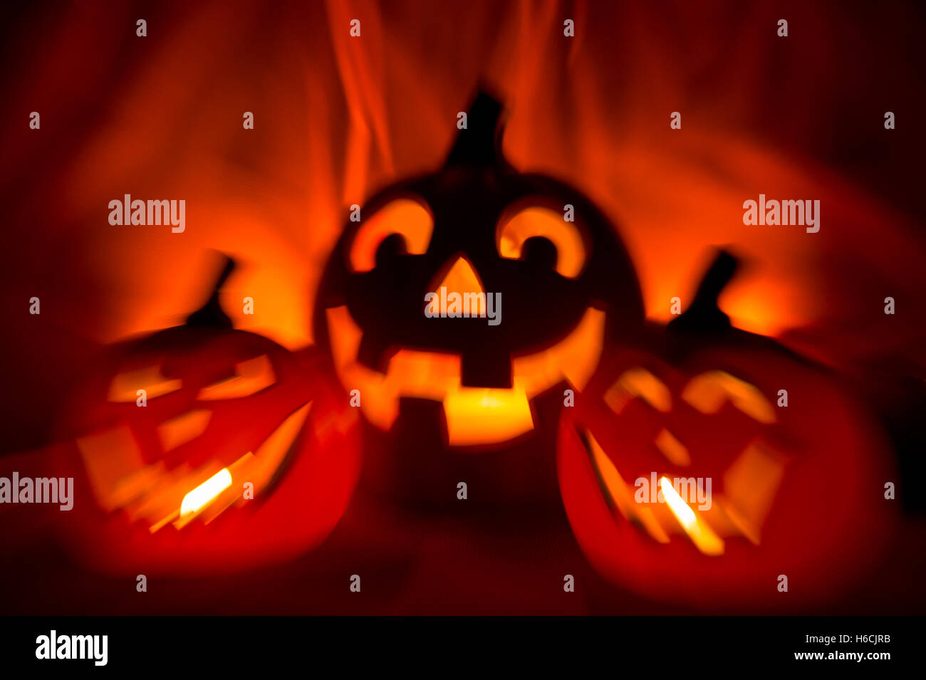 Spooky Halloween Jack-o-Lanterns glowing on a bright orange background ...