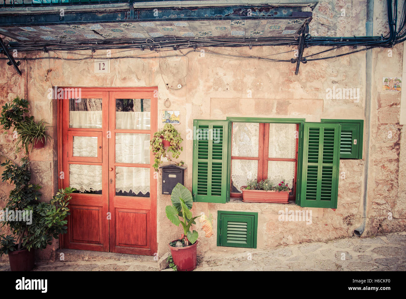 house facade with doors and green window on medieval street in valldemossa spain Stock Photo