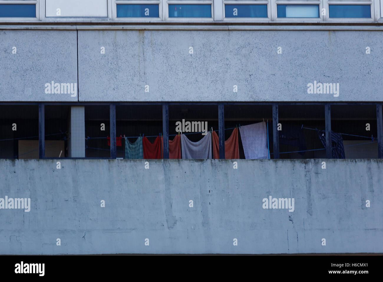 washing drying on the balcony of a concrete brutalist building Stock Photo