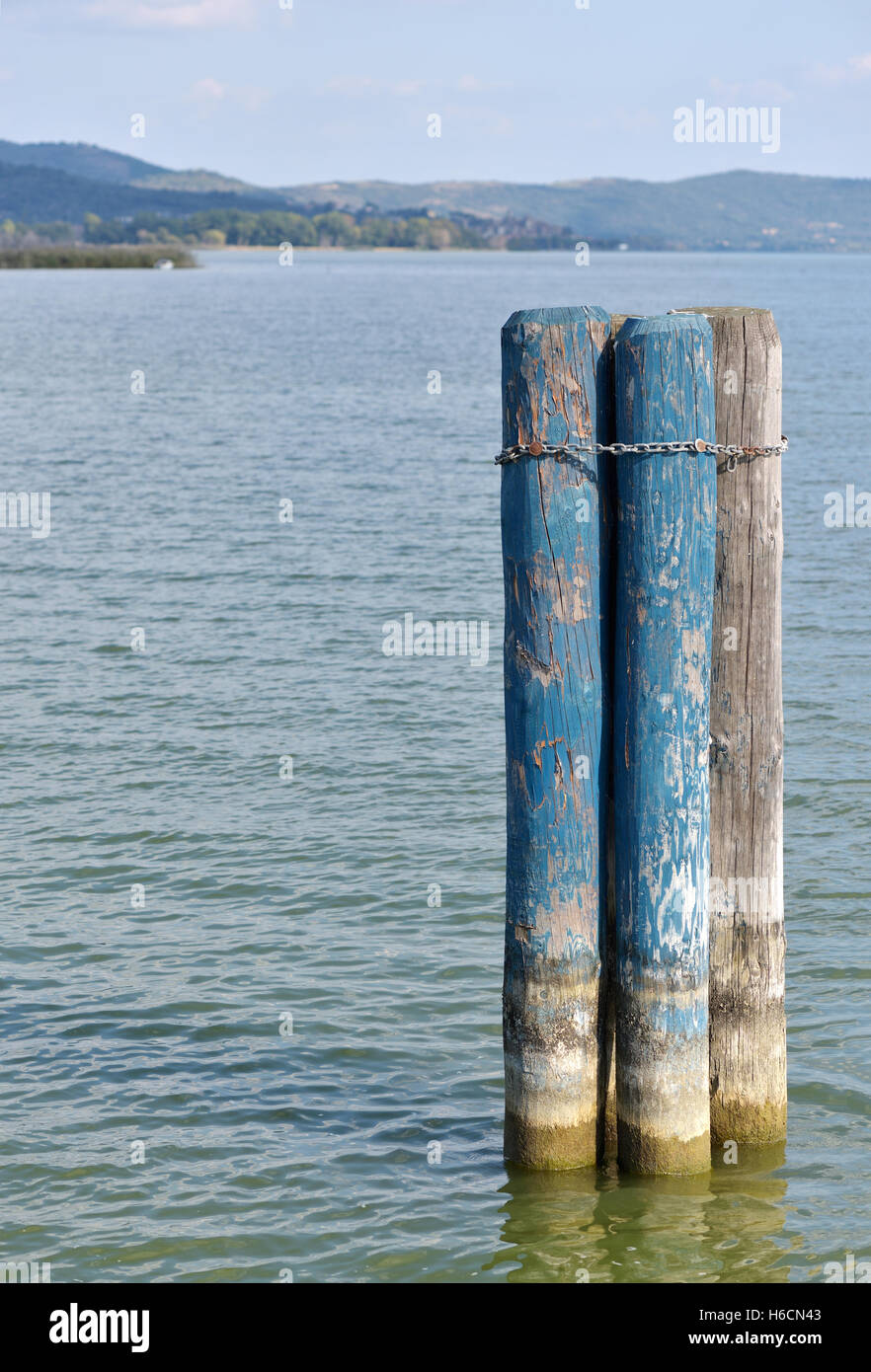 Old log pontoon for boats on lakeside Stock Photo