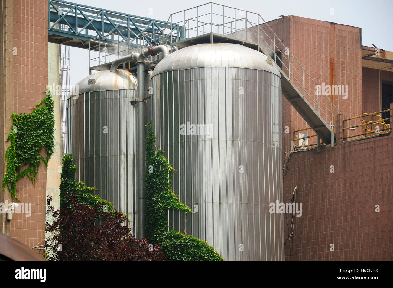 Large distillers on the outside of the Tsing Tao beer factory in Qingdao China. Stock Photo