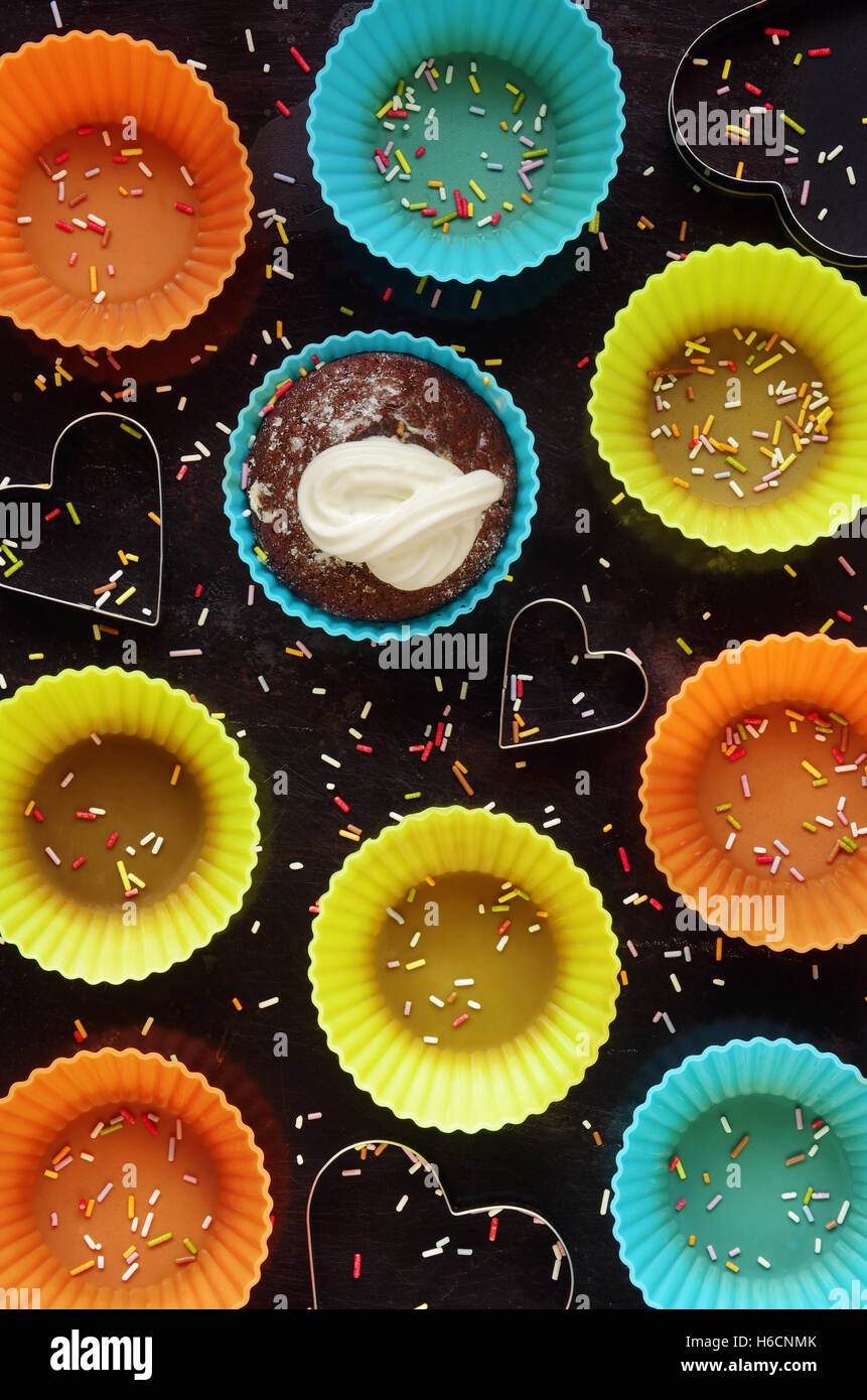 Top view of a group of colorful silicon cupcake forms on dark ...