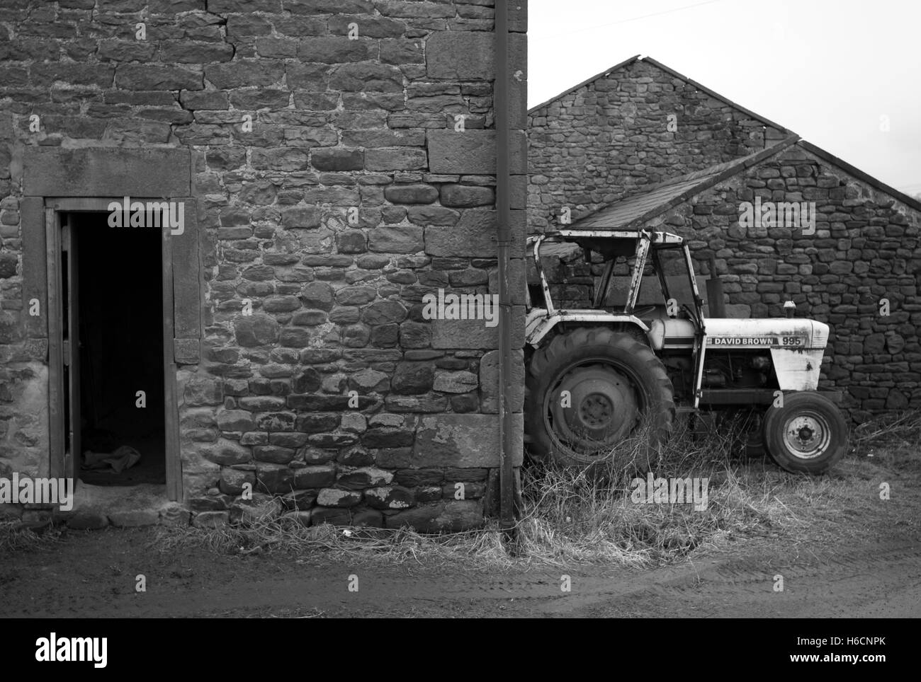 Farm buildings and tractor, Near Wark, Northumberland Stock Photo