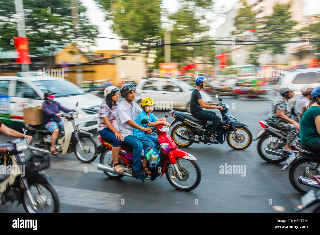 Family on a scooter in heavy traffic, motion blur, Ho Chi Minh City, Vietnam Stock Photo