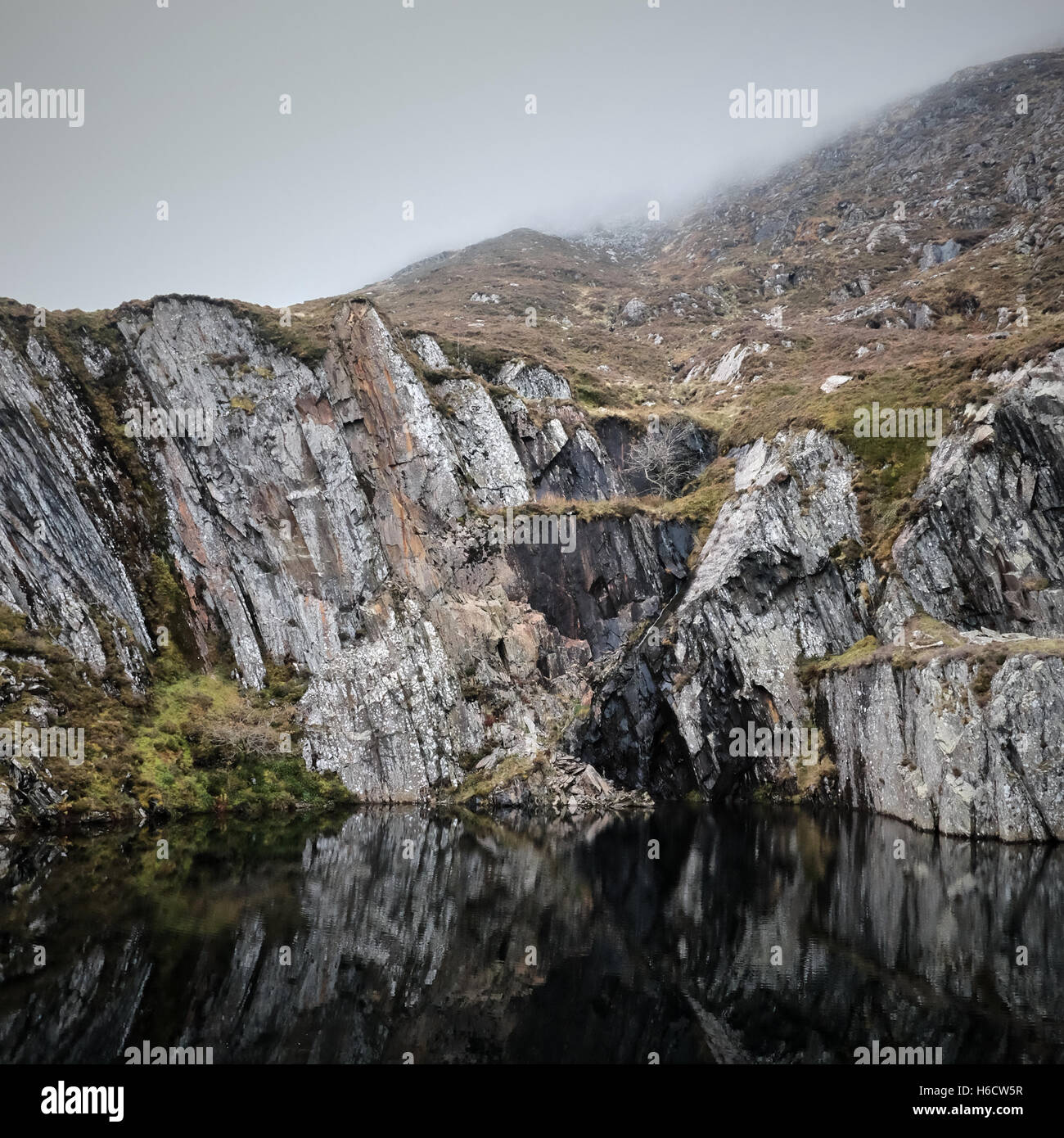 Black water pool in disused slate quarry on the slopes of Carnedd Moel Siabod, Snowdonia, North Wales. U.K. Stock Photo