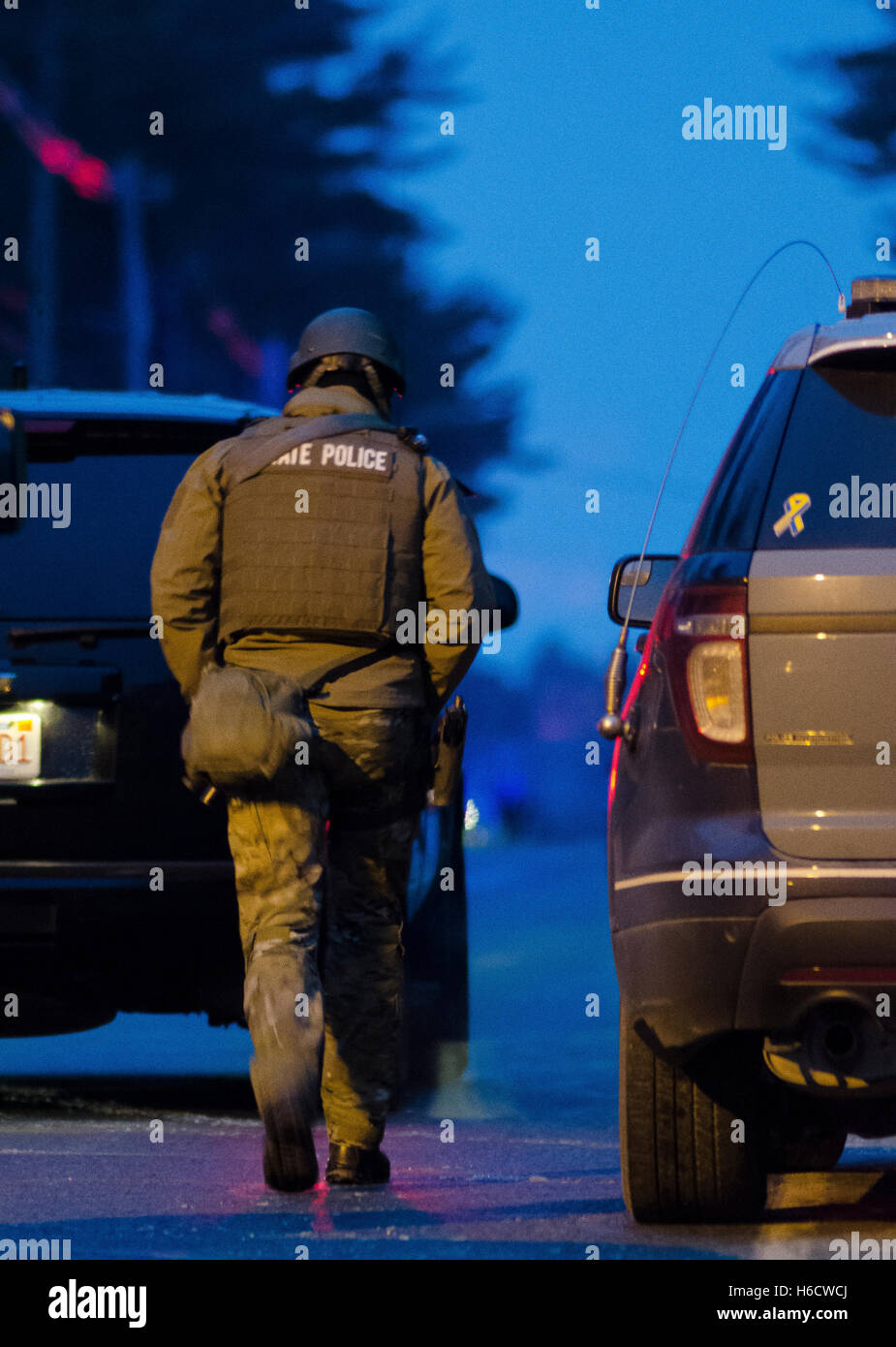 A member of the Massachusetts State Police STOP Team walks towards a