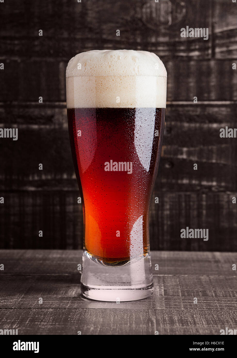 Glass of brown ale beer with foam on wooden background Stock Photo Alamy
