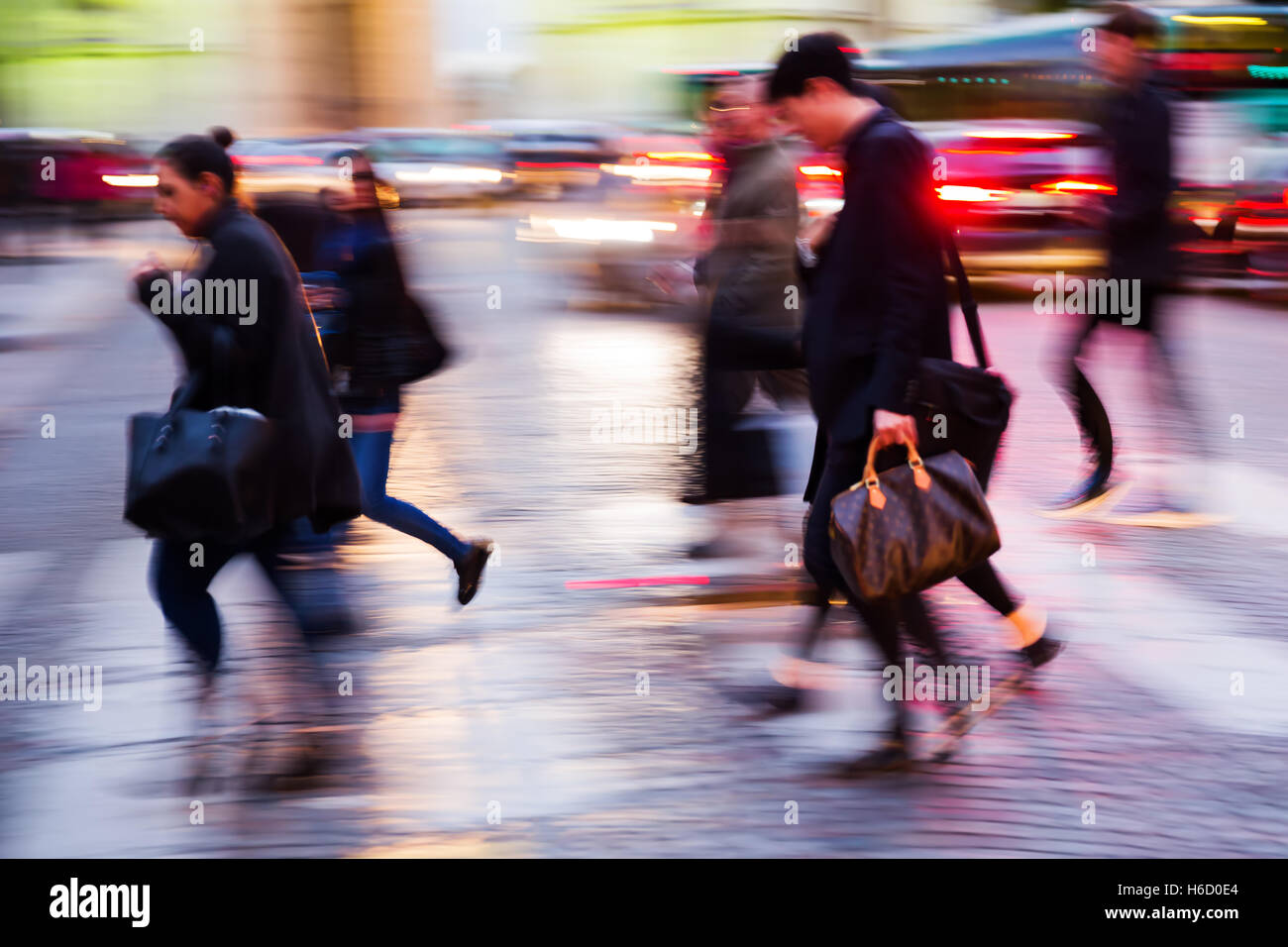 picture in motion blur of people crossing a city street at night Stock ...