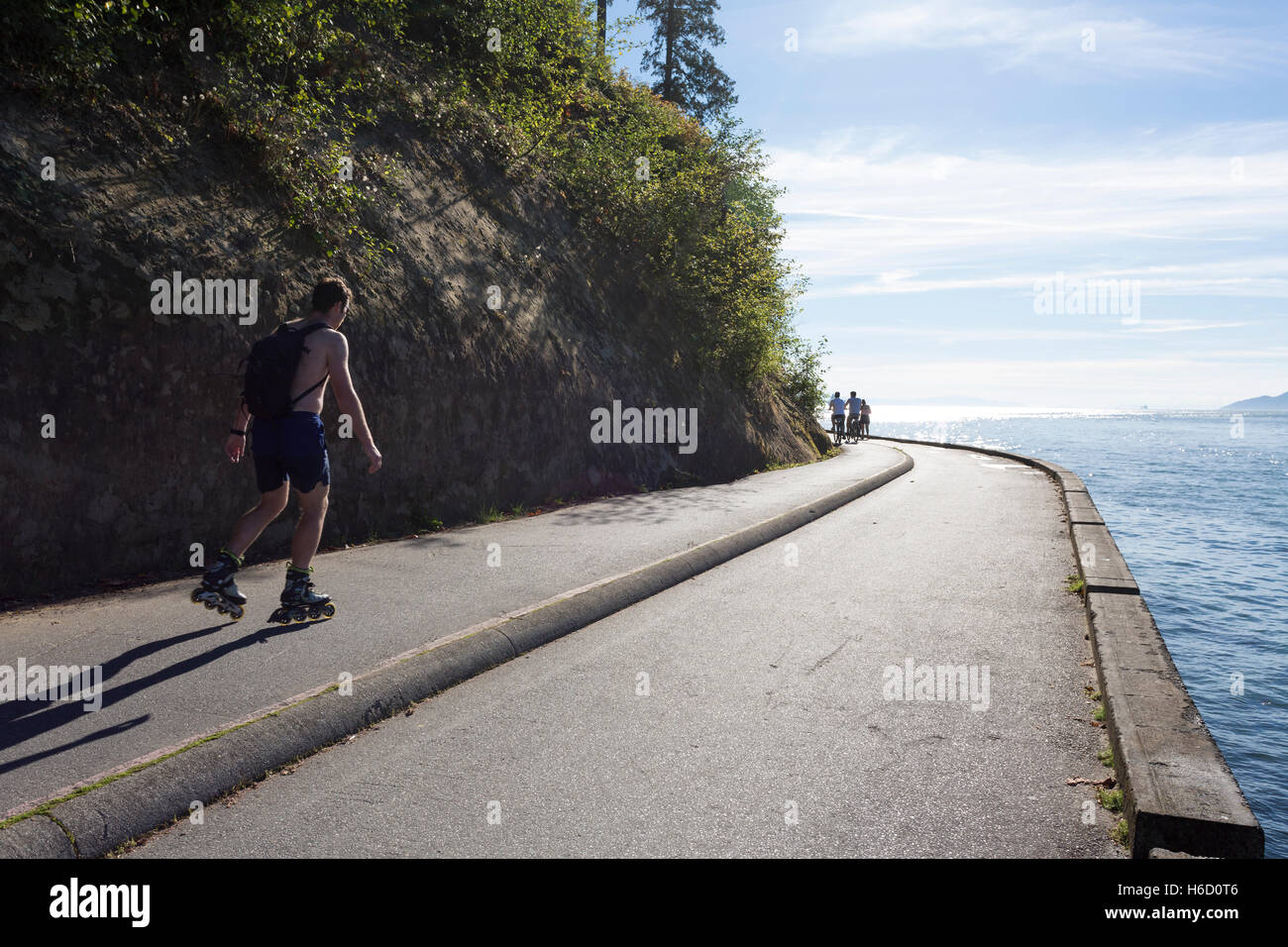 Vancouver, Canada: Man rollerblading along Stanley Park Seawall Loop ...