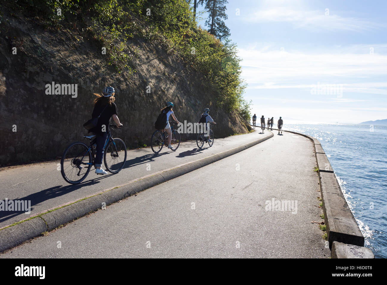 Vancouver, Canada: Group of cyclists riding along Stanley Park Seawall Loop. Stock Photo
