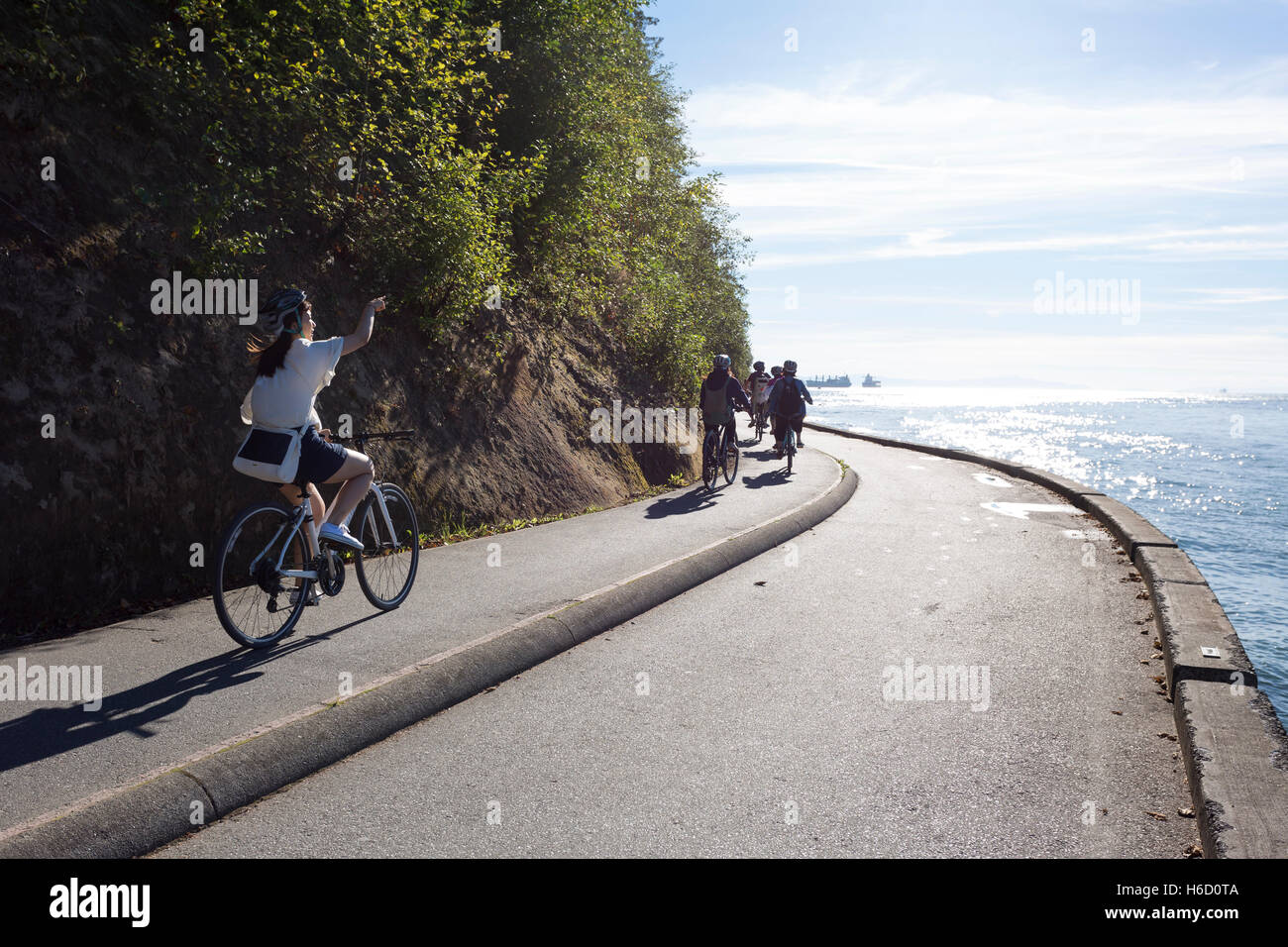 Vancouver, Canada: Group of cyclists riding along Stanley Park Seawall ...