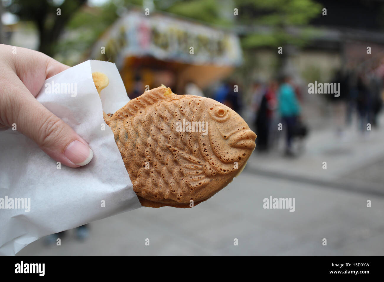 Taiyaki is fish-shaped pancake stuffed with sweetened red bean paste as a common street snack in Japan Stock Photo