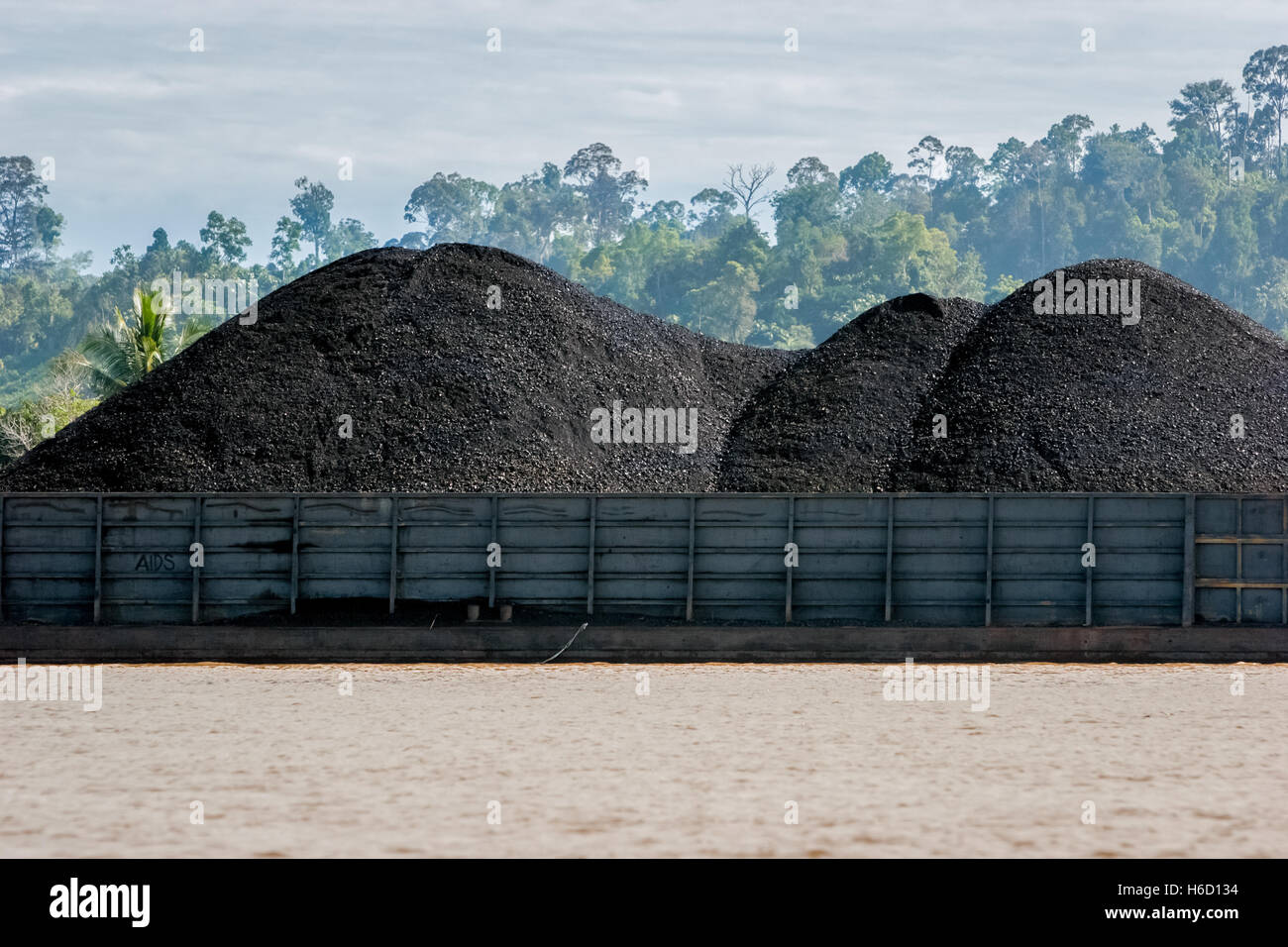 Coal barge on Segah River in Tanjung Redeb, Berau, East Kalimantan, Indonesia. Stock Photo