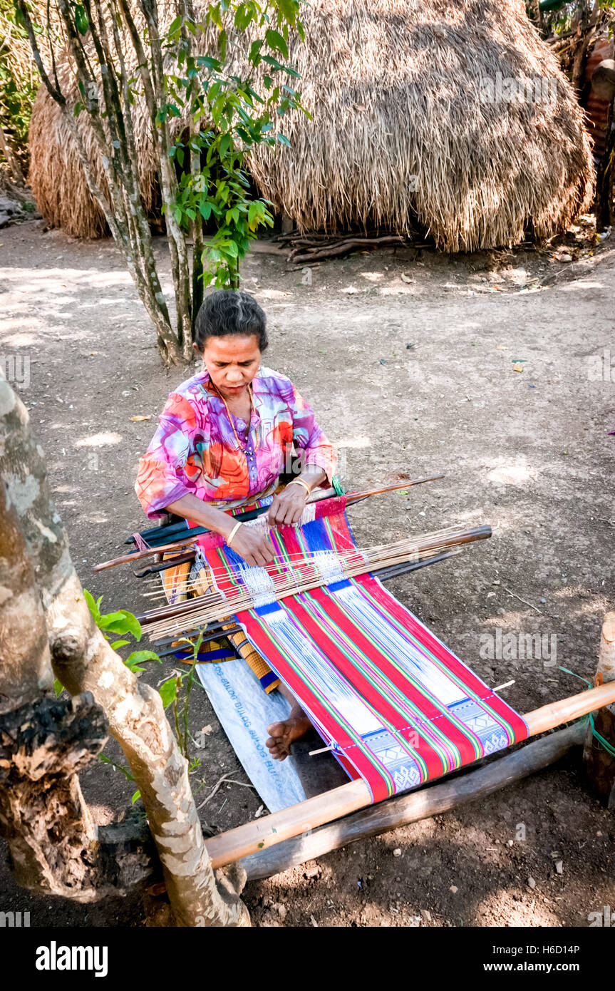 Woman making woven fabric in rural Indonesia. Stock Photo