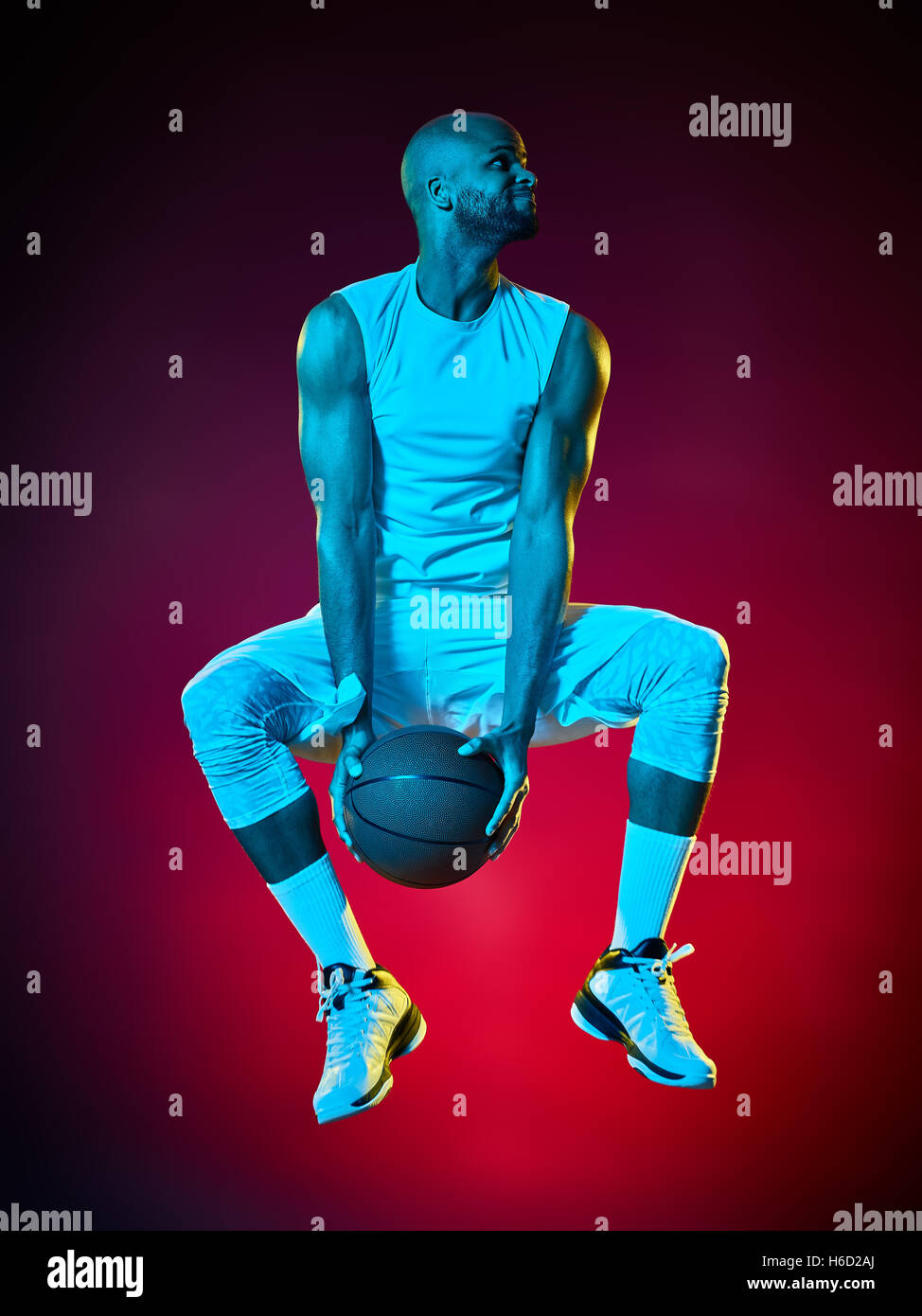 one basketball player man Isolated on black background Stock Photo - Alamy