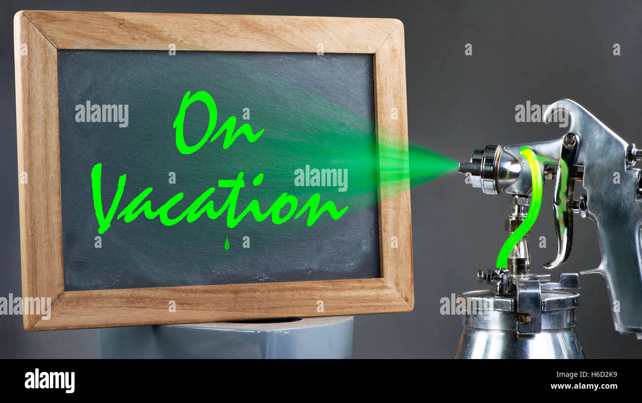 Spray painting a on vacation sign. Stock Photo