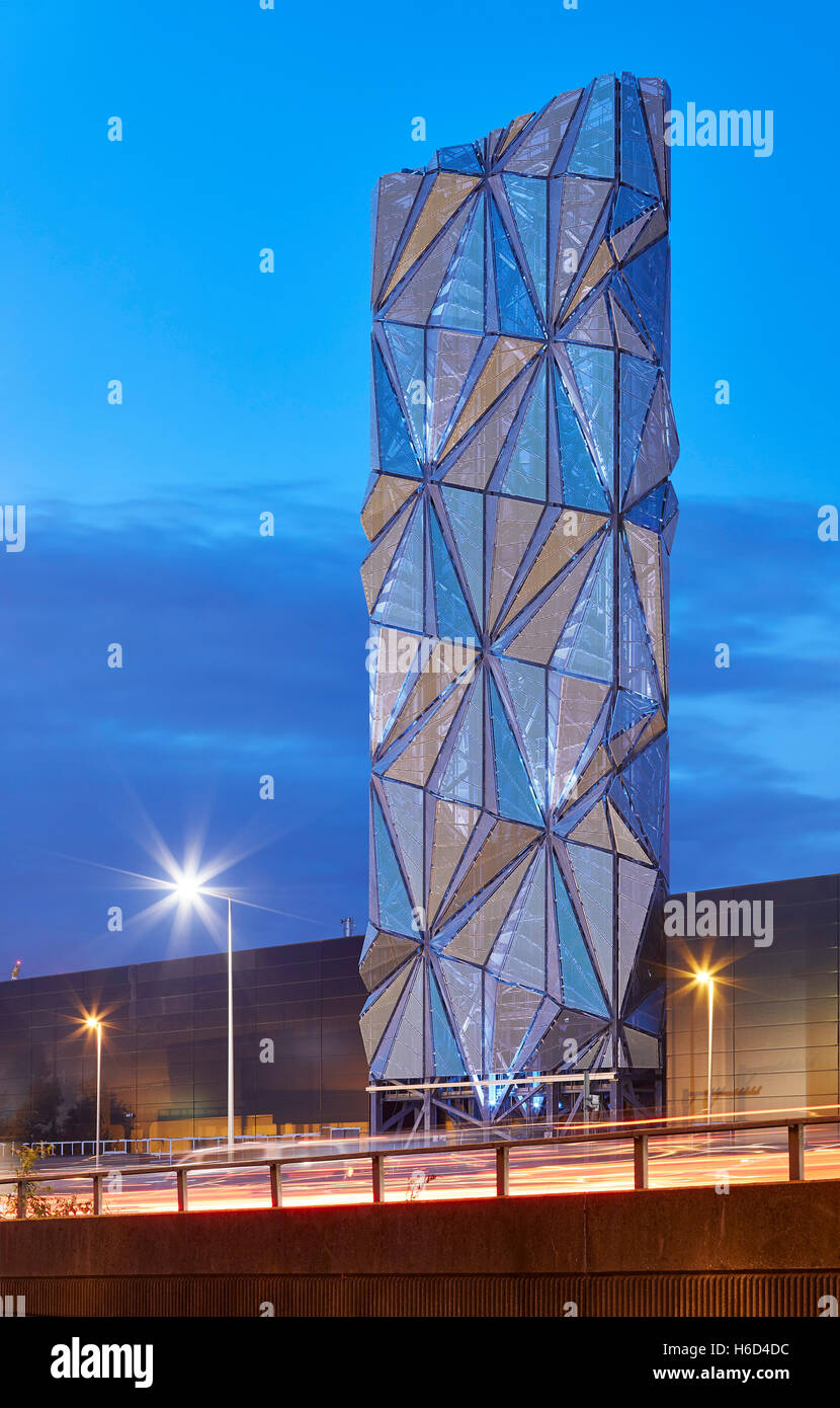 Abstract view of sculptural chimney flue with faceted panels with different colours reflected. Greenwich Energy Centre / The Optic Cloak, Greenwich, United Kingdom. Architect: C.F. Møller / Conrad Shawcross, 2016. Stock Photo