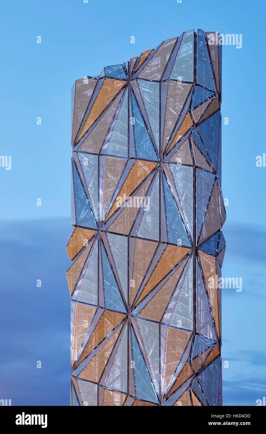 Abstract view of sculptural chimney flue with faceted panels with different colours reflected. Greenwich Energy Centre / The Optic Cloak, Greenwich, United Kingdom. Architect: C.F. Møller / Conrad Shawcross, 2016. Stock Photo